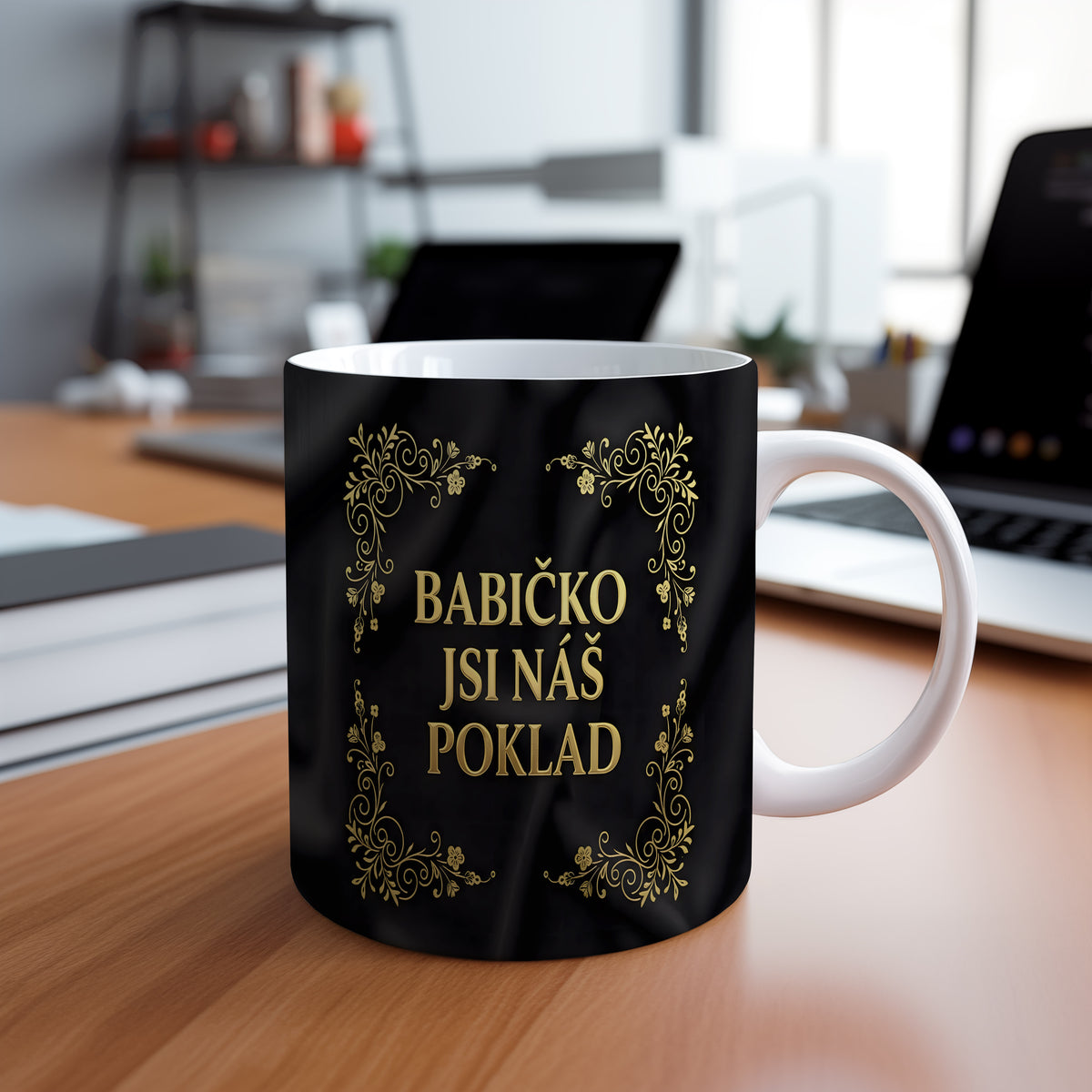 Hrnek s nápisem BABIČKO JSI NÁŠ POKLAD a zlatými ornamenty na černém pozadí.
