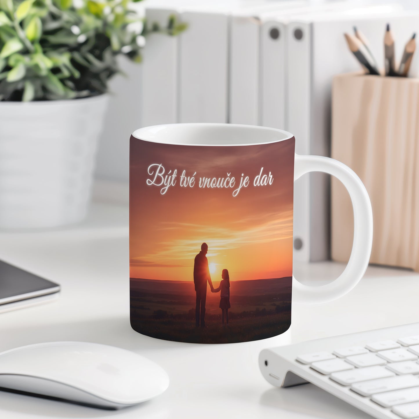 Hrnek s motivem siluety v západu slunce a nápisem Být tvé vnouče je dar.