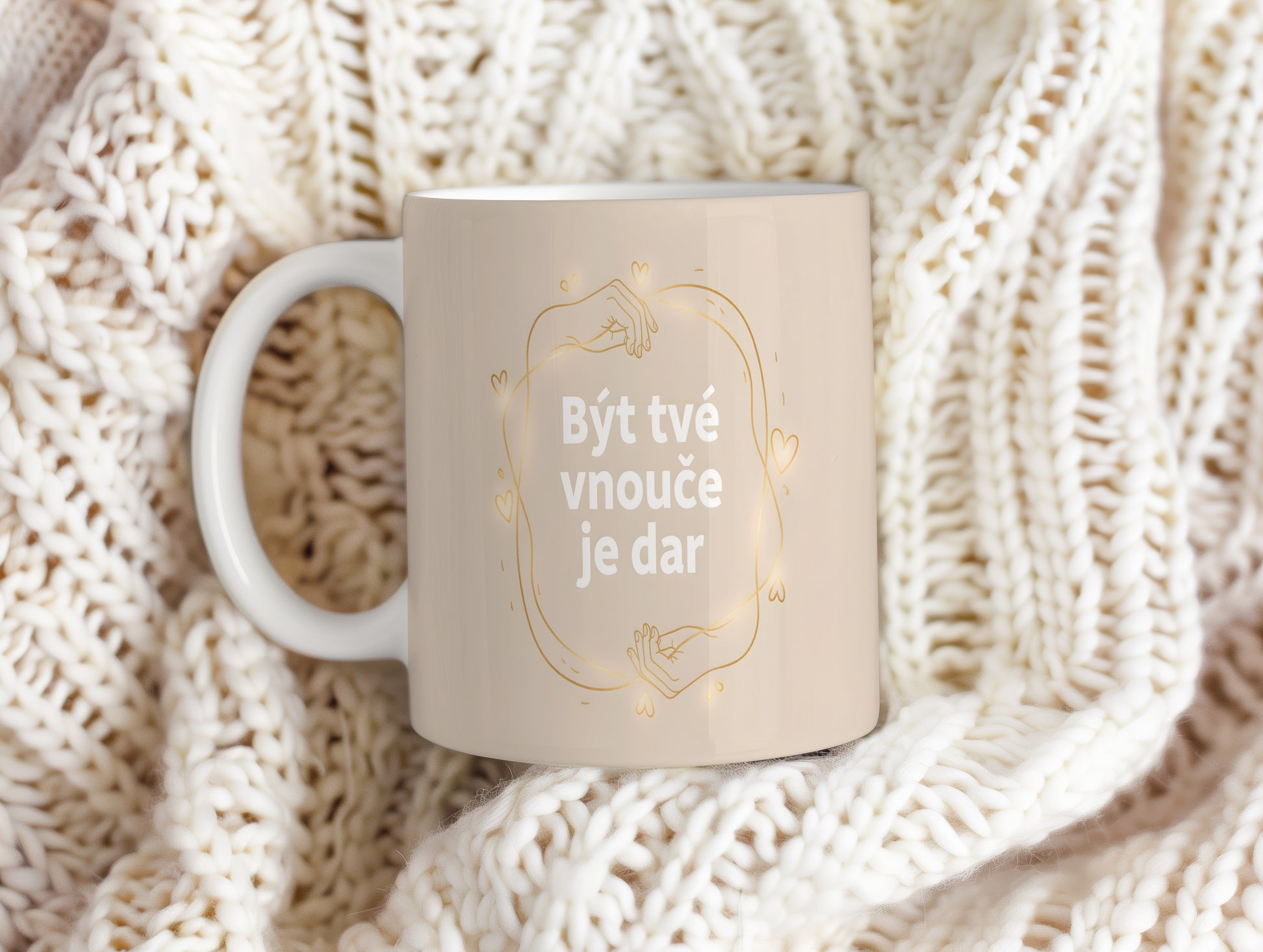 Béžový hrnek s bílým nápisem a zlatými motivy srdcí a rukou.
