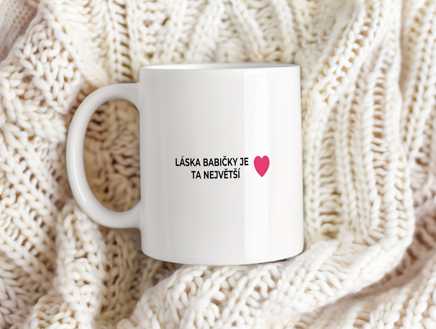 Bílý hrnek s červeným srdcem a nápisem LÁSKA BABIČKY JE TA NEJVĚTŠÍ.