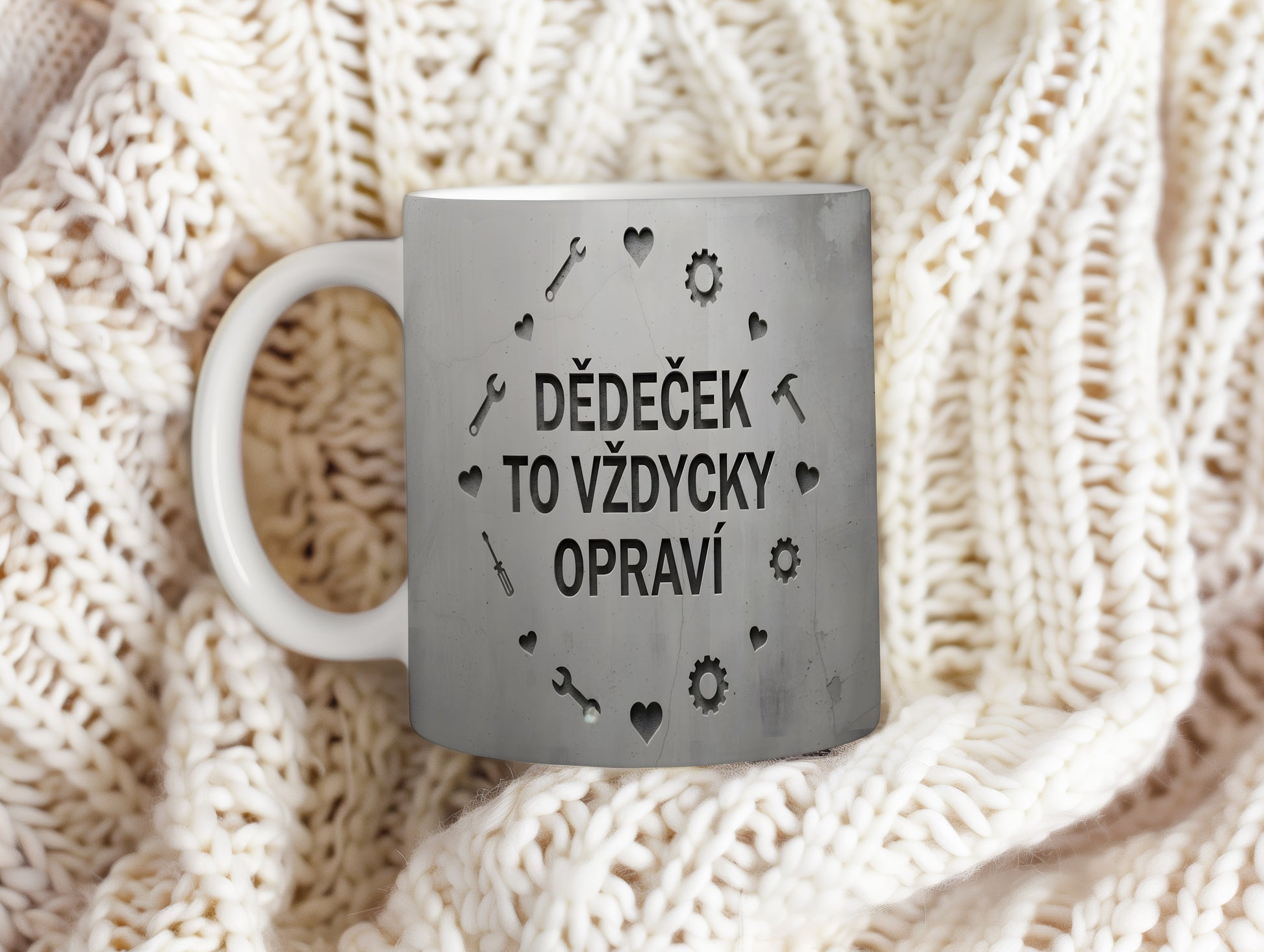 Hrnek s nápisem 'DĚDEČEK TO VŽDYCKY OPRAVÍ' a motivem nářadí na betonovém pozadí.