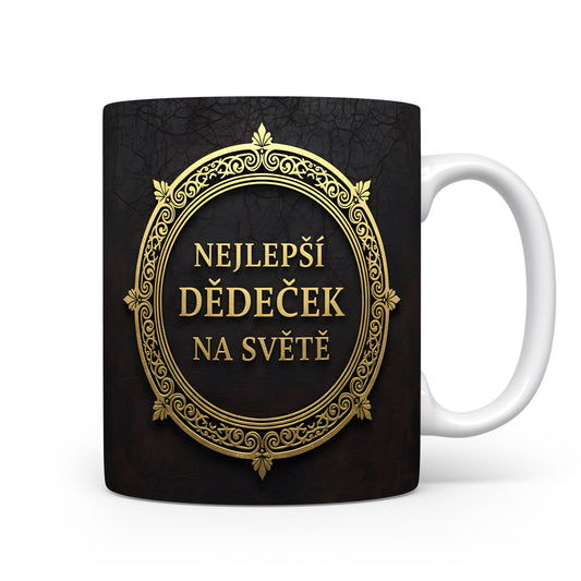 Hrnek s nápisem 'NEJLEPŠÍ DĚDEČEK NA SVĚTĚ' se zlatými ornamenty na černém pozadí.