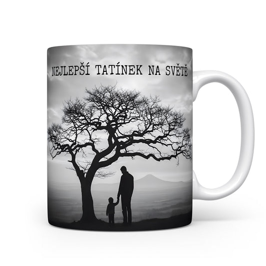 Hrnek s černobílou siluetou otce a dítěte pod stromem.