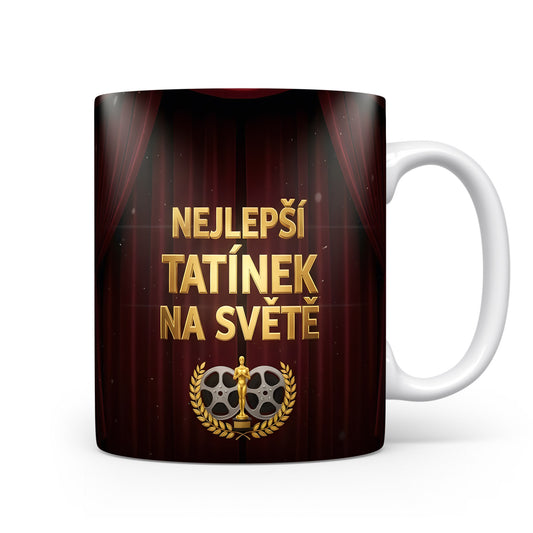 Hrnek s nápisem 'NEJLEPŠÍ TATÍNEK NA SVĚTĚ' a divadelním motivem.