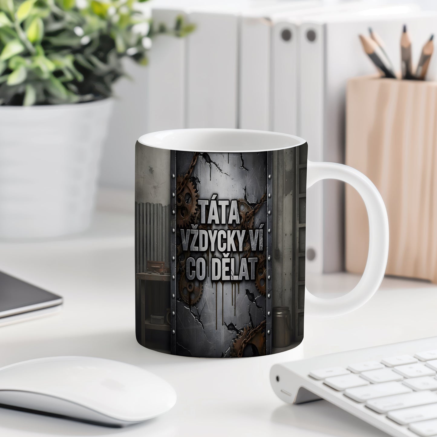 Hrnek s nápisem 'TÁTA VŽDYCKY VÍ CO DĚLAT' a ozubenými koly na kovovém pozadí.