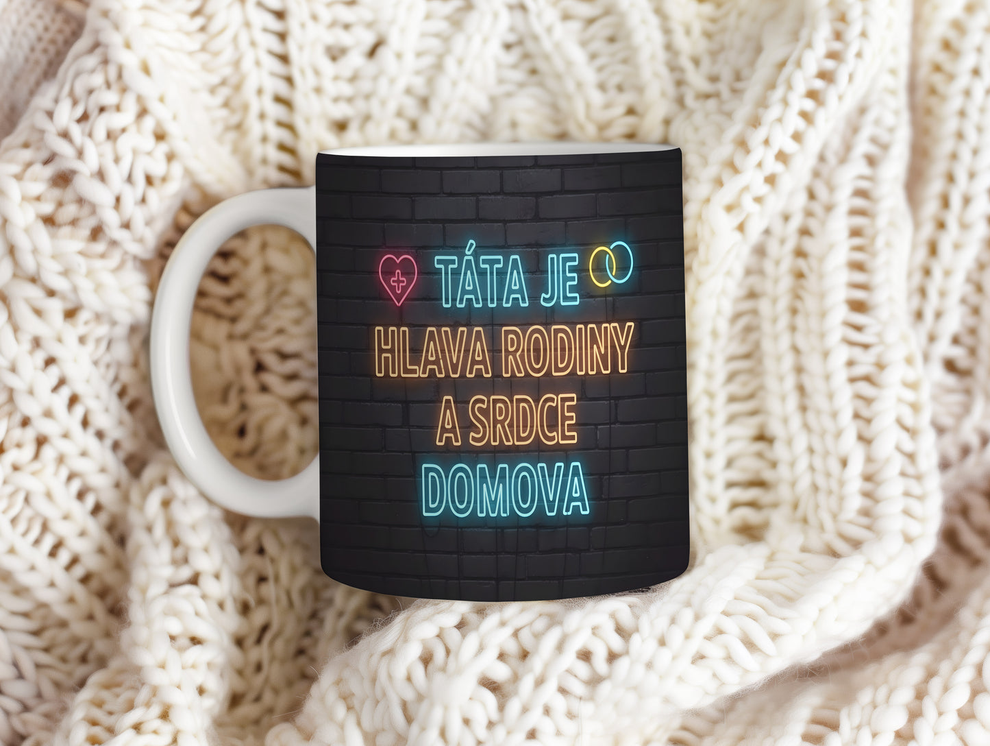 Hrnek s nápisem TÁTA JE HLAVA RODINY A SRDCE DOMOVA na cihlovém pozadí.