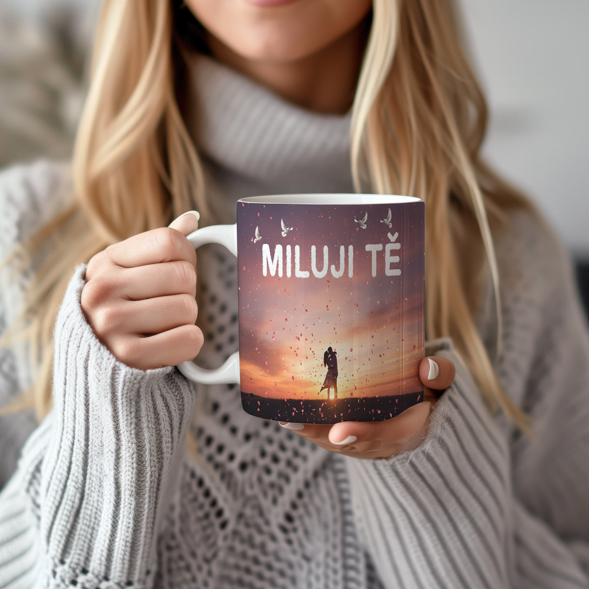 Hrnek s nápisem MILUJI TĚ, párem při západu slunce a okvětními lístky.