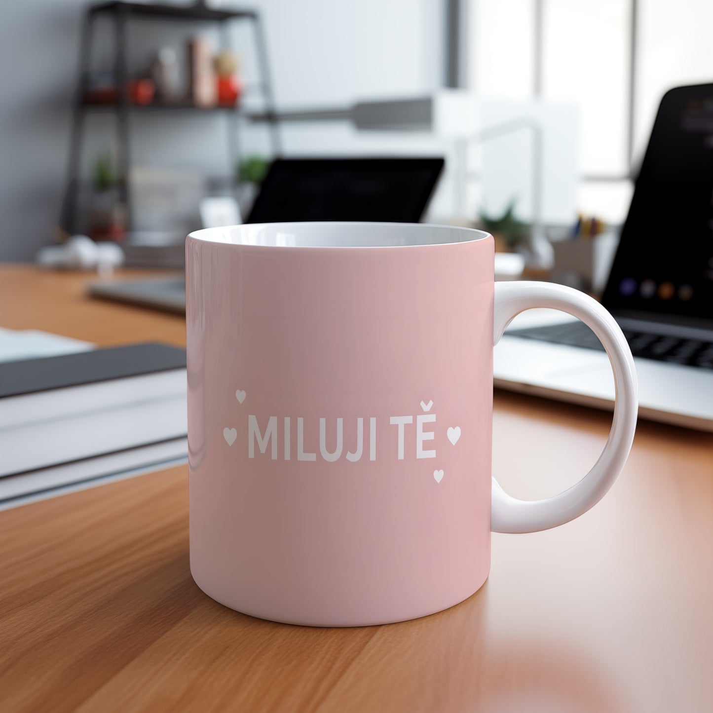 Růžový hrnek s nápisem MILUJI TĚ a malými srdíčky.