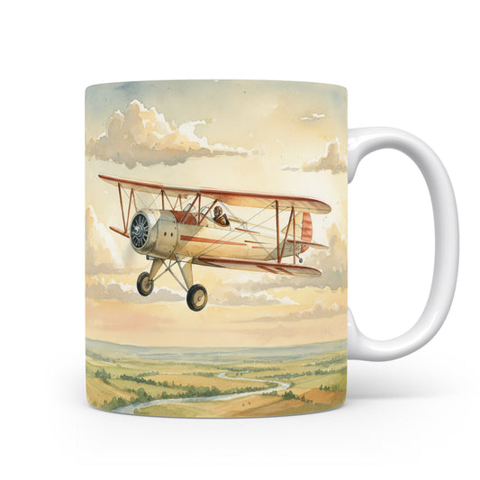 Hrnek s akvarelovým dvojplošníkem v obloze