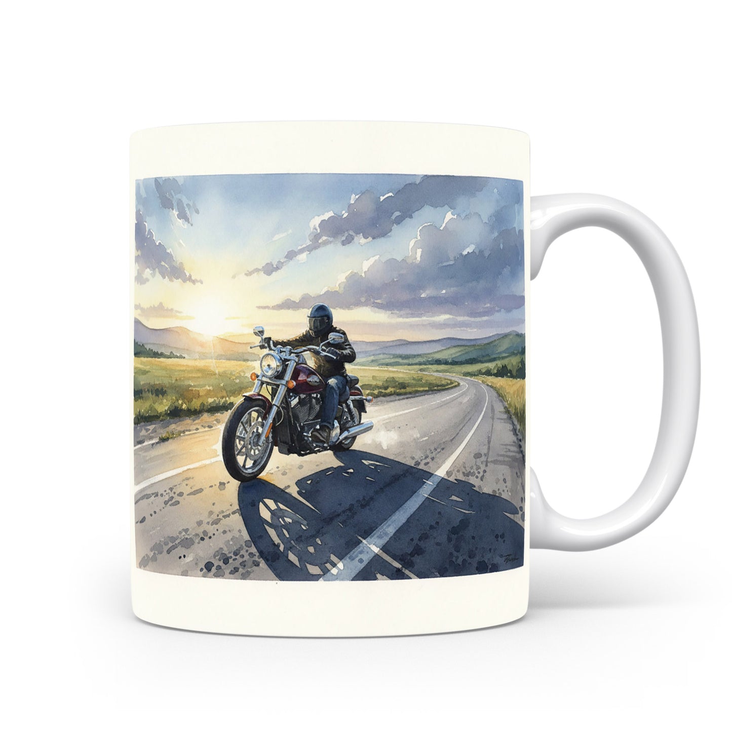 Motorkář na silnici při západu slunce